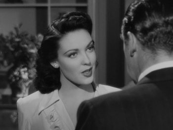 Movie still from “A Letter to Three Wives” (1949), directed by Joseph L. Mankiewicz – A black - and - white photo of a woman talking to a man; Close Up shot, Over the shoulder angle