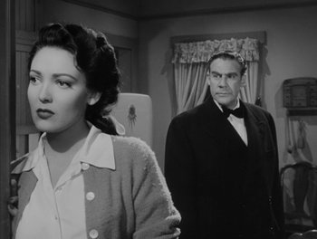 Movie still from “A Letter to Three Wives” (1949), directed by Joseph L. Mankiewicz – A man and a woman standing next to each other in a room; Medium shot, Low angle