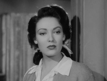 Movie still from “A Letter to Three Wives” (1949), directed by Joseph L. Mankiewicz – A black - and - white photo of a woman in a sweater; Close Up shot, Low angle