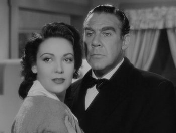 Movie still from “A Letter to Three Wives” (1949), directed by Joseph L. Mankiewicz – A man and a woman posing for a picture; Close Up shot, Low angle