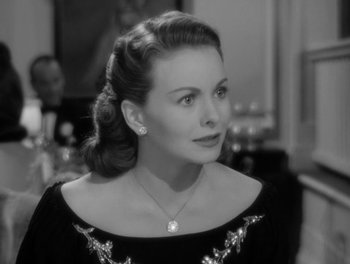 Movie still from “A Letter to Three Wives” (1949), directed by Joseph L. Mankiewicz – A black - and - white photo of a woman in a black dress; Close Up shot, Over the shoulder angle