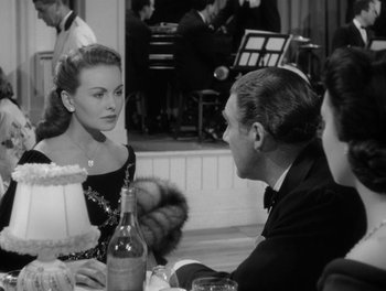 Movie still from “A Letter to Three Wives” (1949), directed by Joseph L. Mankiewicz – A man and a woman sitting at a dinner table; Medium shot, Over the shoulder angle
