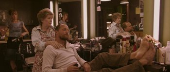 Movie still from “A Prairie Home Companion” (2006), directed by Robert Altman – A group of people sitting in a room; Medium shot, Over the shoulder angle