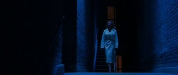 Movie still from “A Prairie Home Companion” (2006), directed by Robert Altman – A woman walking down a set of stairs at night; Wide shot, Low angle