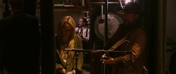 Movie still from “A Prairie Home Companion” (2006), directed by Robert Altman – A man and a woman in a recording studio with microphones; Medium shot, Over the shoulder angle