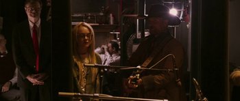 Movie still from “A Prairie Home Companion” (2006), directed by Robert Altman – A man and a woman are playing a guitar; Medium shot, Over the shoulder angle