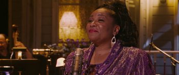 Movie still from “A Prairie Home Companion” (2006), directed by Robert Altman – An older woman is singing into a microphone; Close Up shot, Low angle