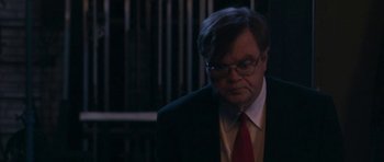 Movie still from “A Prairie Home Companion” (2006), directed by Robert Altman – An older man in a suit and red tie; Close Up shot, Over the shoulder angle