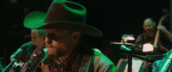 Movie still from “A Prairie Home Companion” (2006), directed by Robert Altman – A man wearing a green cowboy hat; Close Up shot, Low angle