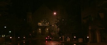 Movie still from “A Prairie Home Companion” (2006), directed by Robert Altman – A car driving down the street in front of a building; Extreme Wide shot, Low angle