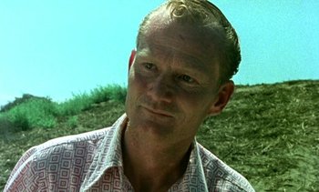 Movie still from “Alambrista!” (1977), directed by Robert M. Young – A person wearing a dress shirt; Close Up shot, Low angle
