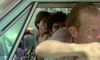 Movie still from “Alambrista!” (1977), directed by Robert M. Young – A group of people sitting in a car; Close Up shot, Low angle