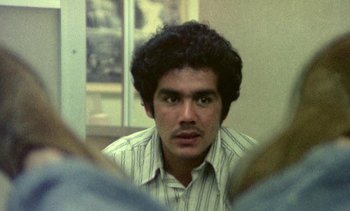 Movie still from “Alambrista!” (1977), directed by Robert M. Young – A man with a beard is looking into a mirror; Close Up shot, Low angle