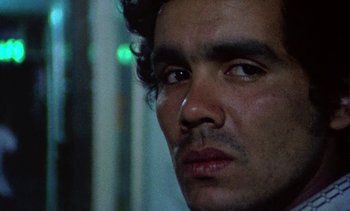 Movie still from “Alambrista!” (1977), directed by Robert M. Young – A man's face with a tear in his eye; Extreme Close Up shot, Low angle