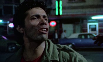 Movie still from “Alambrista!” (1977), directed by Robert M. Young – A person with a mouth open near a street light; Close Up shot, Low angle