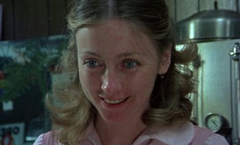 Movie still from “Alambrista!” (1977), directed by Robert M. Young – A person smiling for the camera; Close Up shot, Low angle