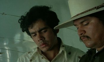 Movie still from “Alambrista!” (1977), directed by Robert M. Young – A man in a white hat and a man in a white shirt; Close Up shot, Low angle