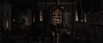 Movie still from “Anastasia” (1956), directed by Anatole Litvak – A group of people standing outside of a building at night; Extreme Wide shot, High angle