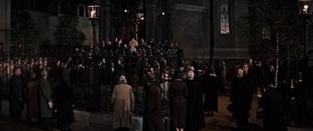 Movie still from “Anastasia” (1956), directed by Anatole Litvak – A group of people standing in front of a building; Extreme Wide shot, High angle