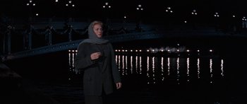 Movie still from “Anastasia” (1956), directed by Anatole Litvak – A person standing in front of a body of water at night; Wide shot, Low angle
