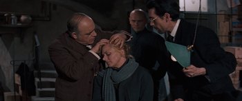 Movie still from “Anastasia” (1956), directed by Anatole Litvak – A group of men standing around a woman; Close Up shot, Over the shoulder angle