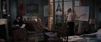 Movie still from “Anastasia” (1956), directed by Anatole Litvak – A man and a woman sitting in a living room next to each other; Wide shot, Over the shoulder angle