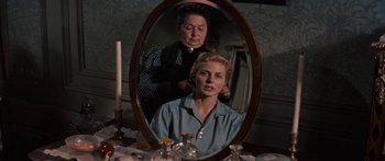 Movie still from “Anastasia” (1956), directed by Anatole Litvak – A woman sitting in front of a mirror looking in the mirror; Medium shot, Over the shoulder angle