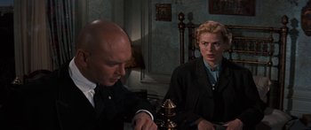 Movie still from “Anastasia” (1956), directed by Anatole Litvak – A man and a woman sitting at a dinner table; Medium shot, Over the shoulder angle