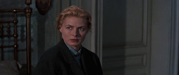 Movie still from “Anastasia” (1956), directed by Anatole Litvak – A woman with blonde hair wearing a suit and tie; Close Up shot, Over the shoulder angle