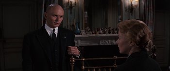 Movie still from “Anastasia” (1956), directed by Anatole Litvak – A man and a woman talking in front of a fireplace; Medium shot, Over the shoulder angle