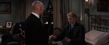 Movie still from “Anastasia” (1956), directed by Anatole Litvak – A man and a woman in a suit and tie holding hands; Medium shot, Over the shoulder angle