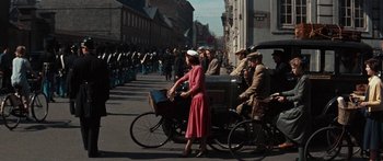 Movie still from “Anastasia” (1956), directed by Anatole Litvak – A woman in a pink dress is riding a bicycle; Extreme Wide shot, High angle