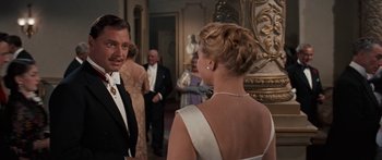 Movie still from “Anastasia” (1956), directed by Anatole Litvak – A man and a woman in formal wear talking to each other; Medium shot, Over the shoulder angle