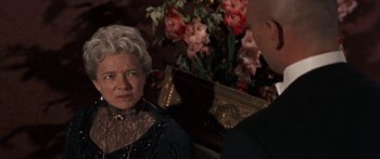 Movie still from “Anastasia” (1956), directed by Anatole Litvak – An older woman and a younger man in front of flowers; Close Up shot, Over the shoulder angle