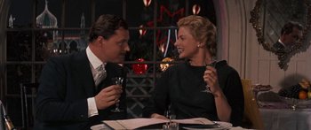 Movie still from “Anastasia” (1956), directed by Anatole Litvak – A man and a woman sitting at a table with wine glasses; Medium shot, Over the shoulder angle