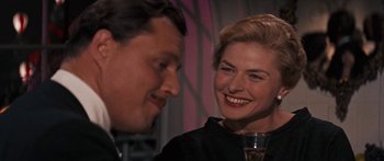 Movie still from “Anastasia” (1956), directed by Anatole Litvak – A man and a woman are smiling at each other; Close Up shot, Over the shoulder angle
