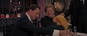 Movie still from “Anastasia” (1956), directed by Anatole Litvak – A man and a woman laughing while sitting next to each other; Medium shot, Over the shoulder angle