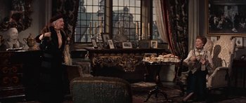 Movie still from “Anastasia” (1956), directed by Anatole Litvak – A living room filled with lots of furniture and a large window; Wide shot, High angle