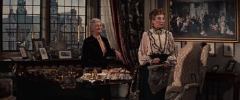 Movie still from “Anastasia” (1956), directed by Anatole Litvak – Two older women standing next to each other in front of a window; Medium shot, Over the shoulder angle
