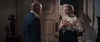 Movie still from “Anastasia” (1956), directed by Anatole Litvak – A man and a woman standing in front of a door; Medium shot, Over the shoulder angle