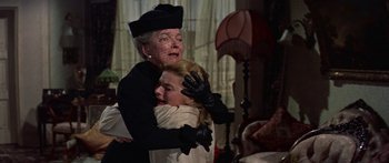 Movie still from “Anastasia” (1956), directed by Anatole Litvak – An older woman hugging a younger woman in a room; Medium shot, Low angle