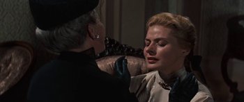 Movie still from “Anastasia” (1956), directed by Anatole Litvak – An older woman is putting lipstick on a younger woman; Close Up shot, Over the shoulder angle