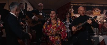 Movie still from “Anastasia” (1956), directed by Anatole Litvak – A woman singing in front of a group of people; Medium shot, High angle