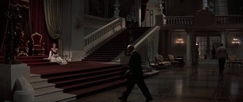 Movie still from “Anastasia” (1956), directed by Anatole Litvak – A man in a suit walking down a set of stairs; Extreme Wide shot, High angle