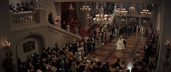 Movie still from “Anastasia” (1956), directed by Anatole Litvak – A crowd of people in formal wear standing in front of a staircase; Extreme Wide shot, High angle