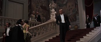 Movie still from “Anastasia” (1956), directed by Anatole Litvak – A man in a tuxedo walking down the stairs; Wide shot, Low angle