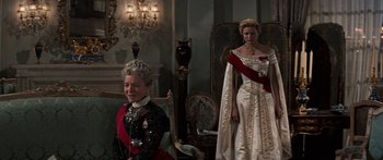 Movie still from “Anastasia” (1956), directed by Anatole Litvak – Two women dressed up in formal wear in a room; Medium shot, Low angle