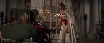 Movie still from “Anastasia” (1956), directed by Anatole Litvak – Two women dressed up in historical clothing shaking hands; Medium shot, Over the shoulder angle
