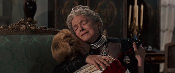 Movie still from “Anastasia” (1956), directed by Anatole Litvak – A woman in a crown is hugging another woman in a dress; Close Up shot, High angle