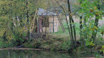 Movie still from “Antonia's Line” (1995), directed by Marleen Gorris – A small cabin in the middle of a forest; Extreme Wide shot, High angle